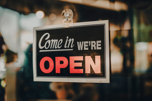 A small business shop front with an open sign in the window